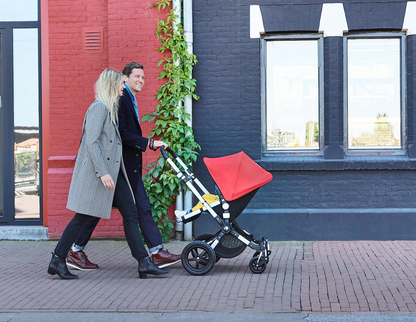 Couple on a walk with baby stroller