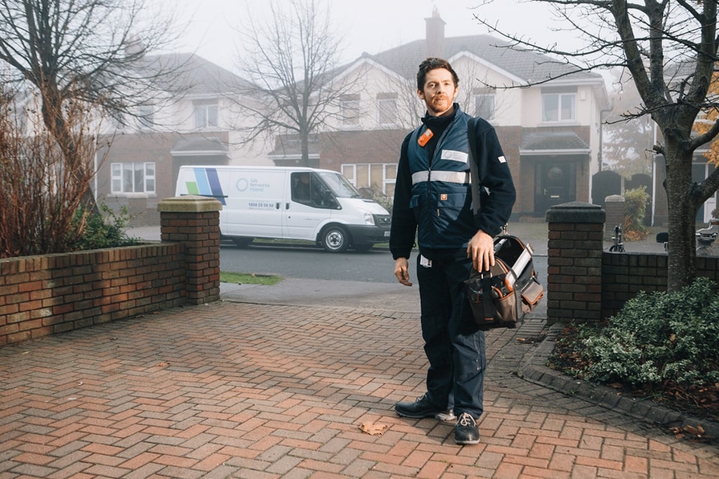 Ireland gas employee standing in the entrance of a house