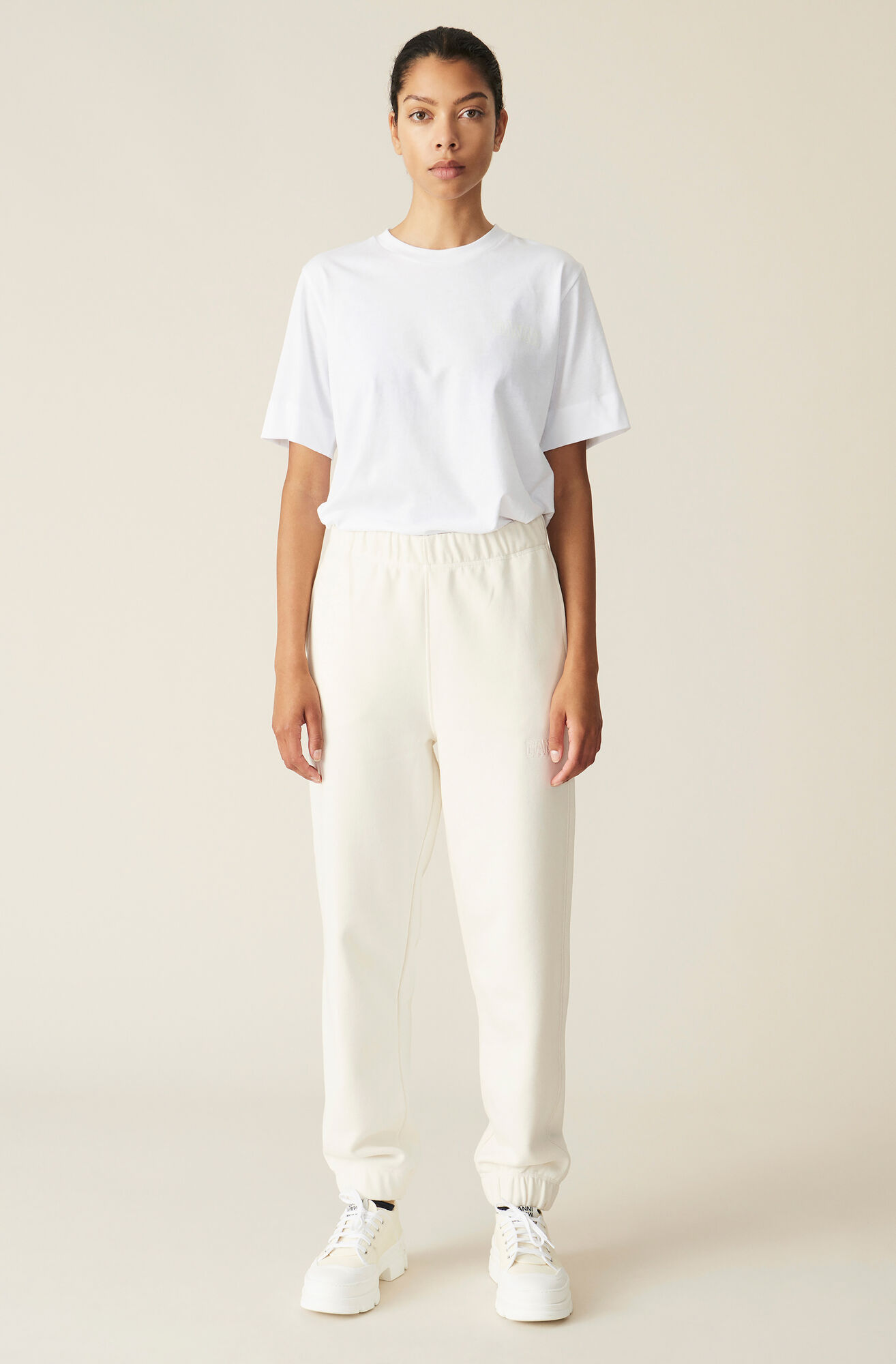 woman wearing white ganni sweatpants