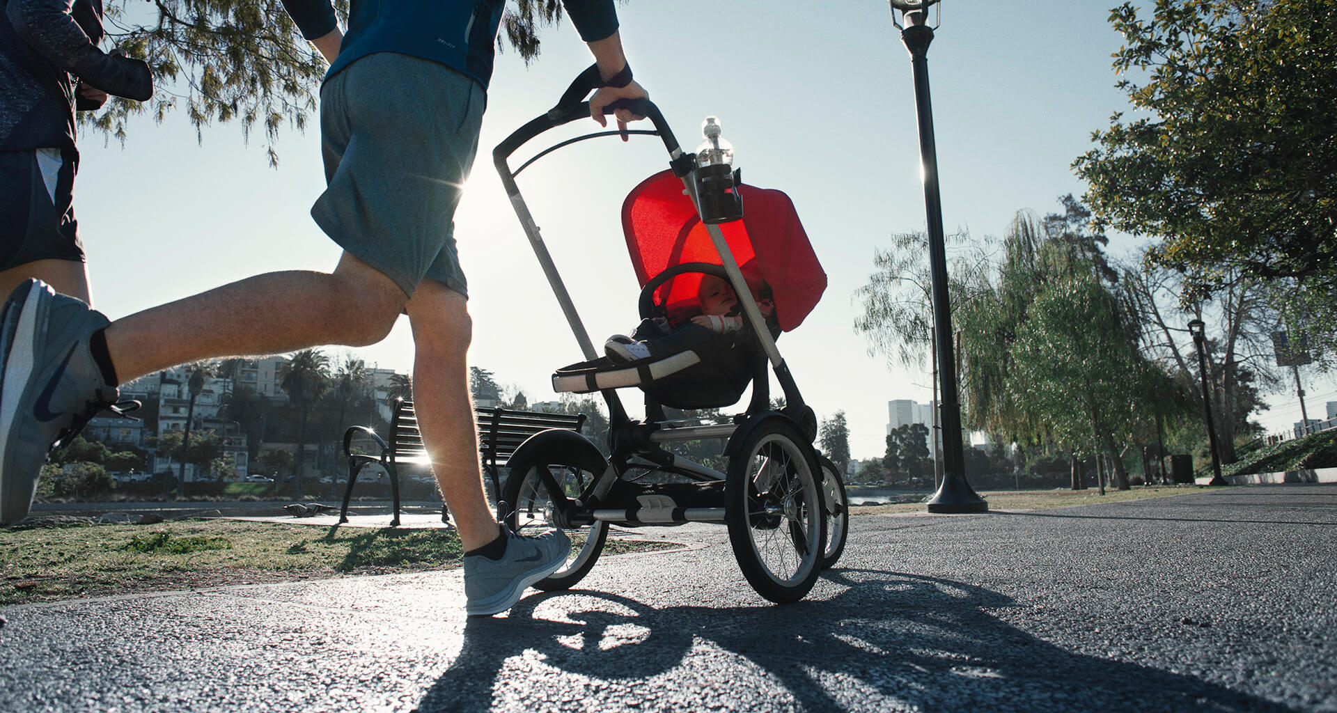 Runner running with a pink baby stroller