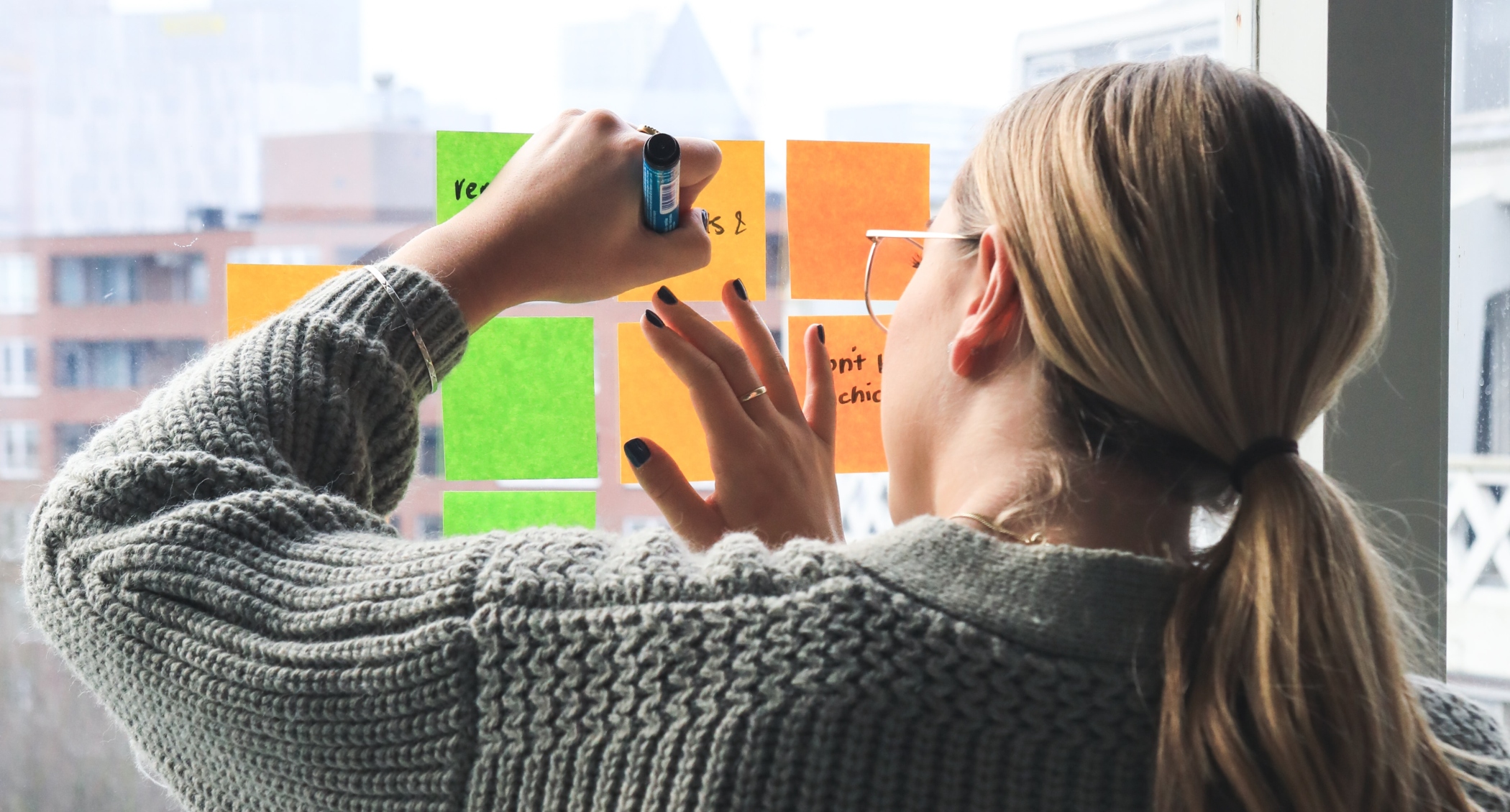woman writing on post its