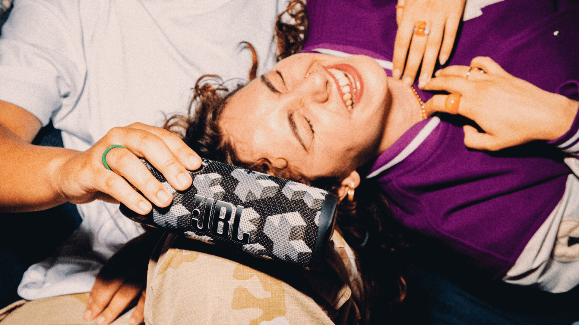 woman lying on persons lap laughing