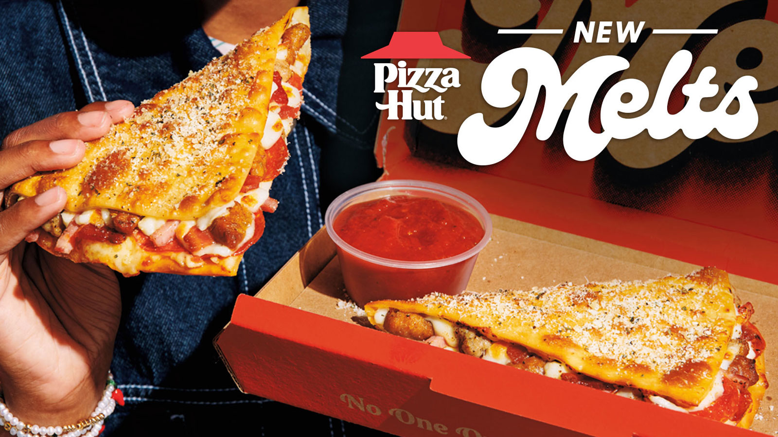 Close up of a cheesy, delicious Pizz Hut Melt with tomato dipping sauce.