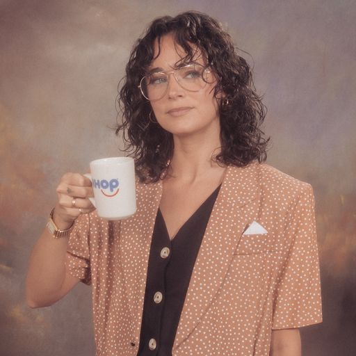 Headhsot of Rachel Caires holding an iHop mug.