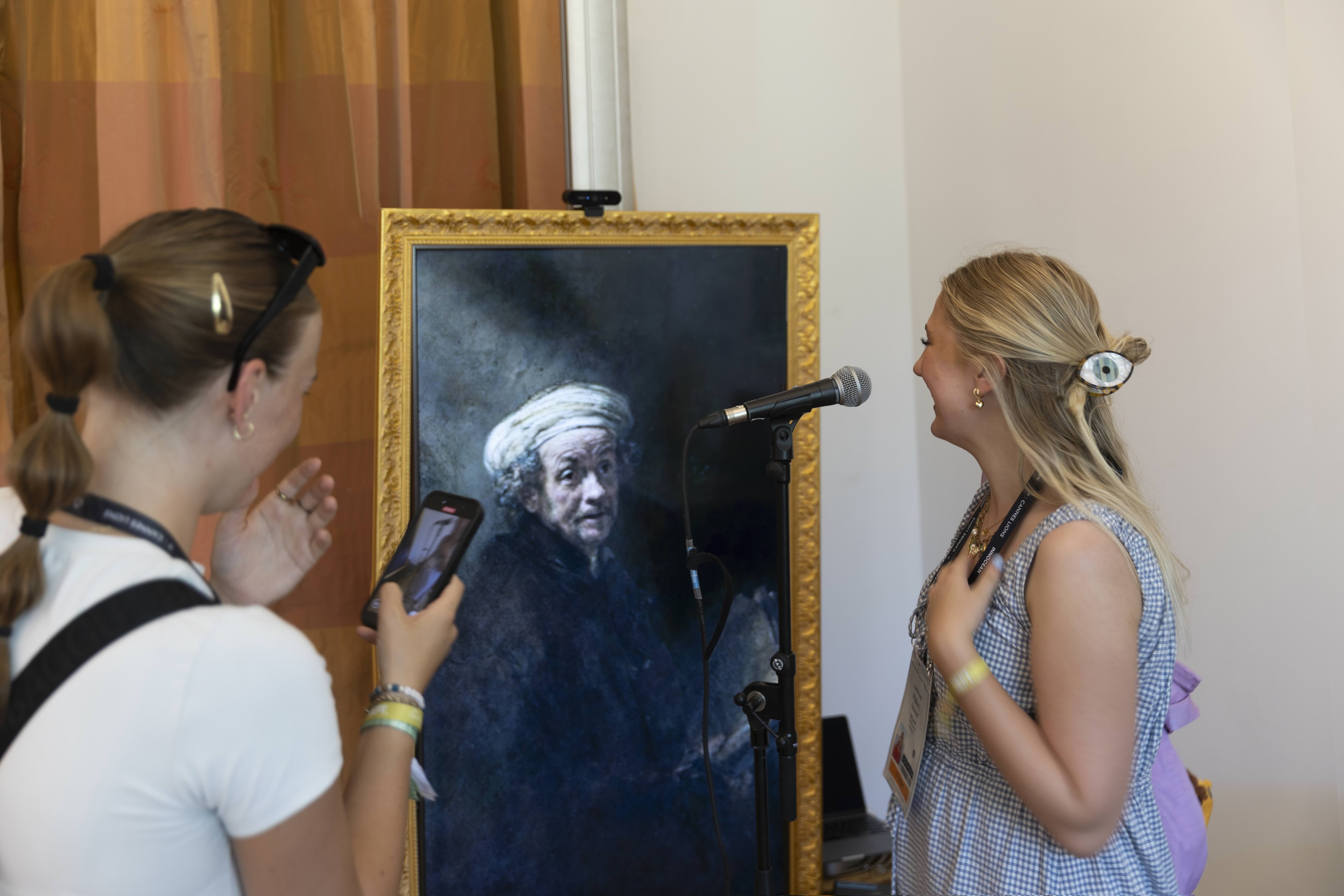 people talking to the Rembrandt portrait